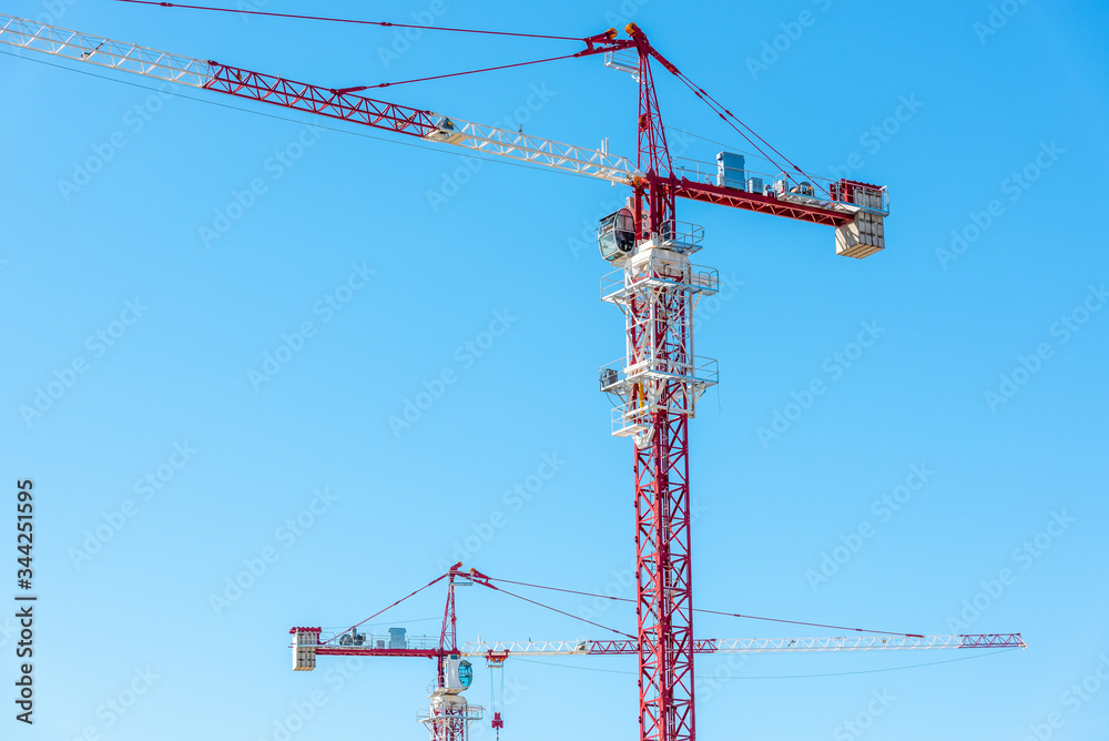Tower crane, red against the sky and mountains Tower crane, red against the sky and mountains