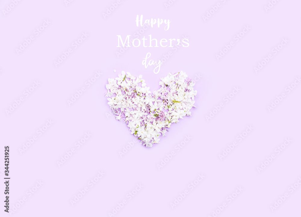 Heart of lilac flowers on a light background, with the inscription . Holiday content.