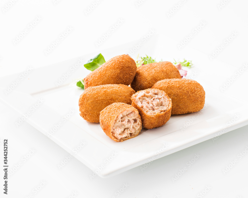 Tasty cut croquettes on square plate