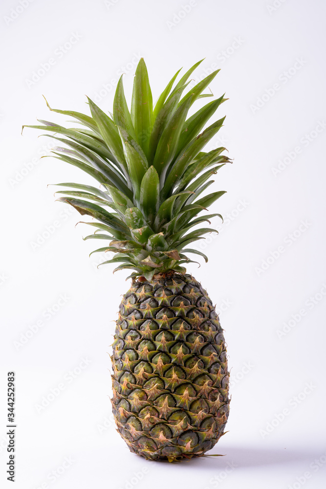 Portrait Of Ripe Pineapple Against White Background Portrait Of Ripe Pineapple Against White Background