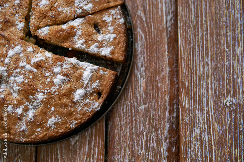 Homemade pie with cherries and apples on a dark rustic wooden board background. Rustic style food Homemade pie with cherries and apples on a dark rustic wooden board background. Rustic style food