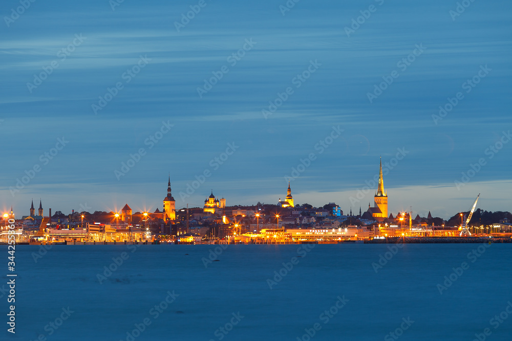 Scenic blue hour view of old town and harbor skyline. Tallinn, Estonia.