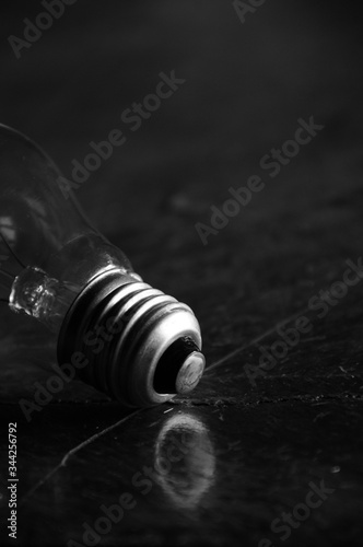 Still life of light bulb on wooden table.