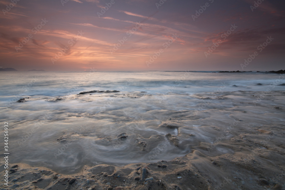 Getxo, Bizkaia/Basque Country; May 16, 2012. Colorful sunset at Azkorri beach at low tide Getxo, Bizkaia/Basque Country; May 16, 2012. Colorful sunset at Azkorri beach at low tide