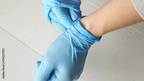 showing how to remove blue protective gloves correctly