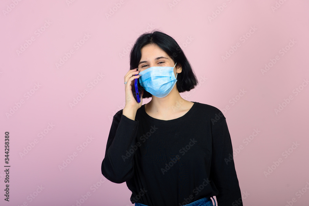 The caucasian girl in blue colored protective face mask. The caucasian girl in blue colored protective face mask.