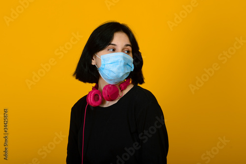 The caucasian girl in blue colored protective face mask.