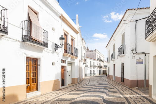 a cobbled street with typical white houses in Olivença (Olivenza) town, province of Badajoz, Extremadura, Portugal/Spain