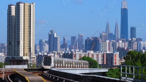 KUALA LUMPUR, MALAYSIA - FEBRUARY 21, 2020: Malaysia MRT (Mass Rapid Transit) train with the background of Kuala Lumpur city. MRT is a transportation for the future generation. photo