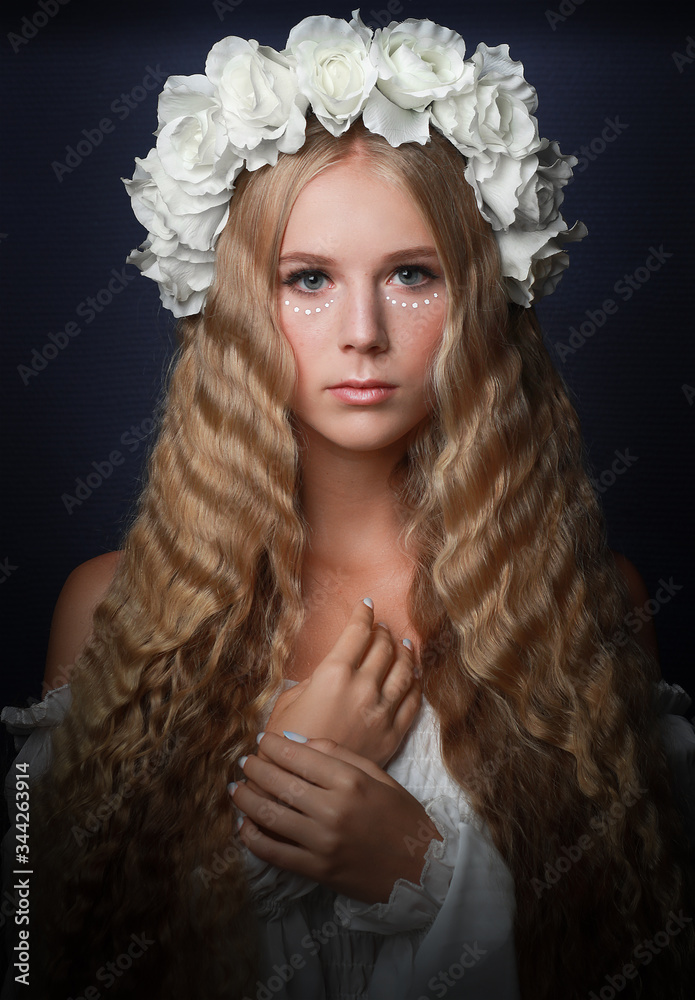 beautiful long haired blonde girl in flower crown and white dress