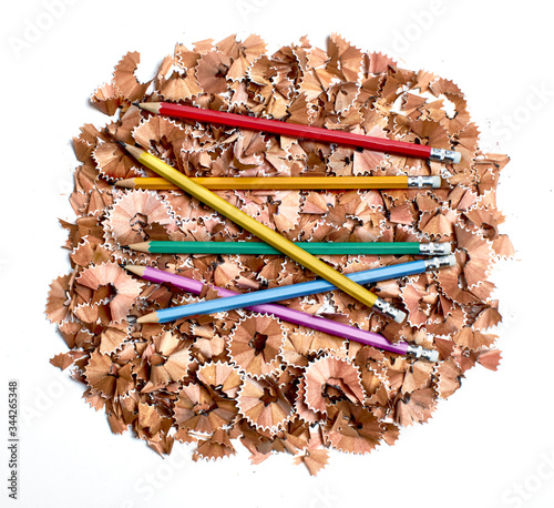 Colorful pencils on pile of pencil shavings photo