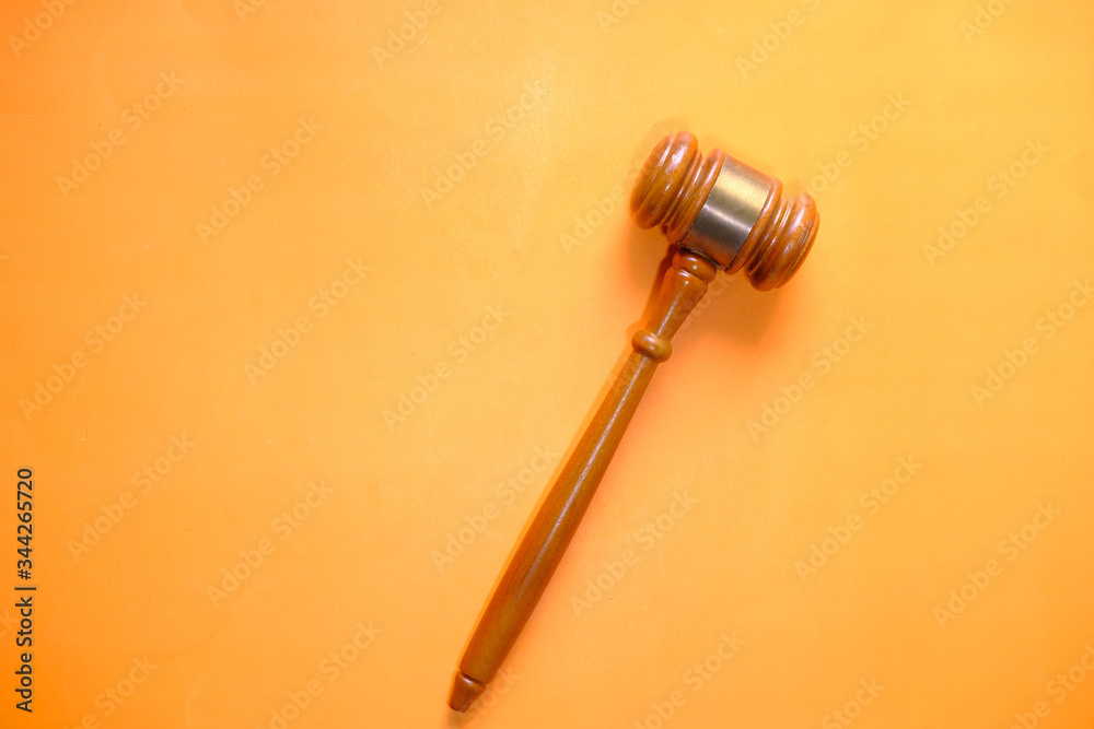 top view of gavel on orange background top view of gavel on orange background