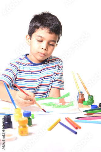 Little Indian kid drawing and painting