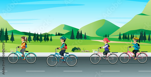 Children riding bicycles to school with a mountain in the background.