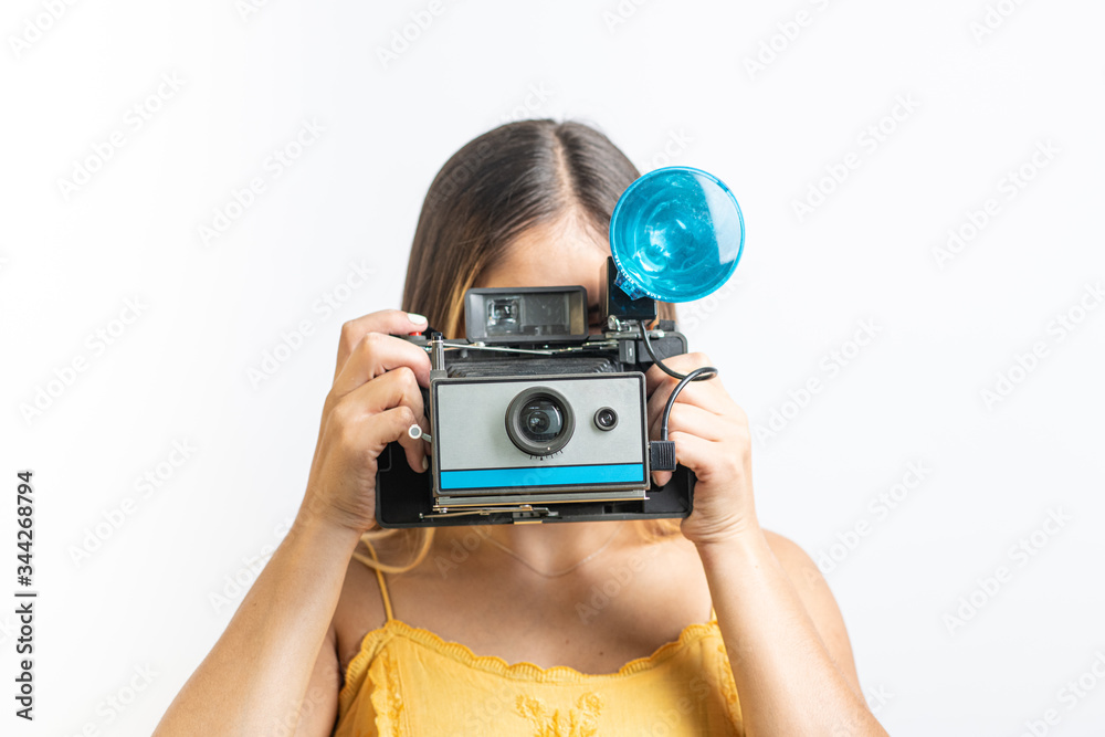 Girl holding vintage instant camera