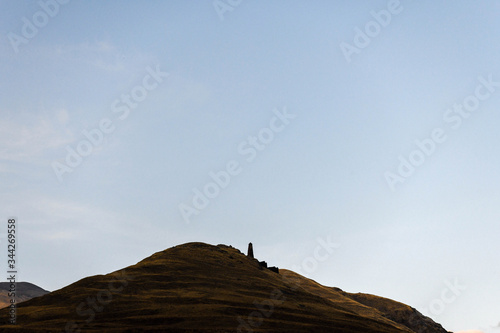 The medieval tower of Kvavlo overlooking with mountains in the background.