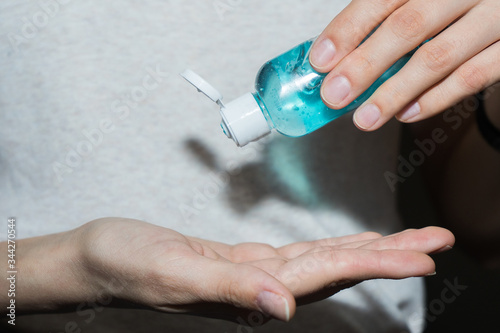 .Antispetic sanitizer in hands. The girl treats her hands with an antibacterial agent. Disinfection gel for the prevention of coronavirus covid-19 2019-ncov. photo