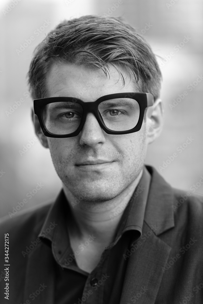Face of young nerd businessman with eyeglasses outdoors in black and white Face of young nerd businessman with eyeglasses outdoors in black and white