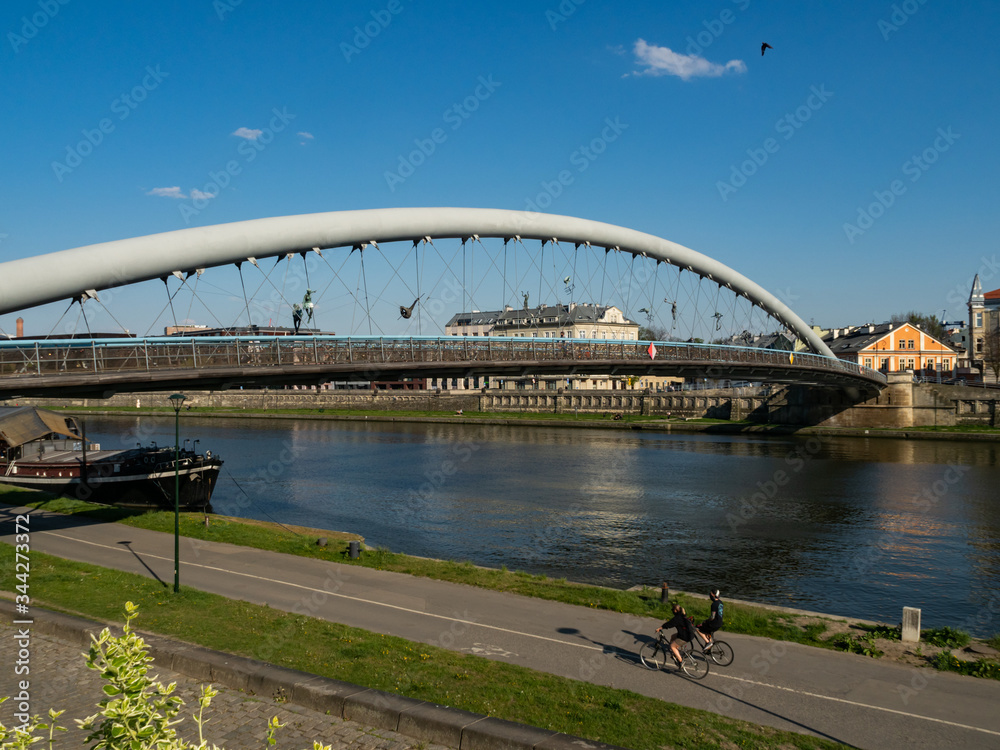 Obraz premium Vie over vistula river, boulevards and Bernatka footbridge. Cracow, Poland