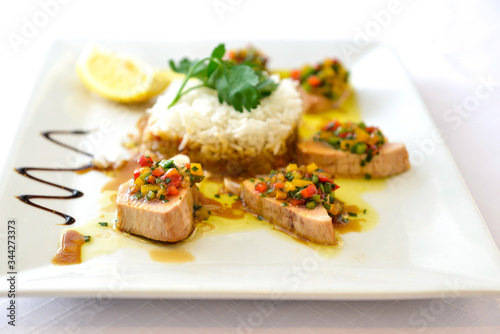 delicieous flat cooking tuna rice small vegetables in a white plate
