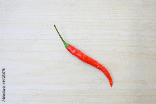 Red chilli pepper on clean wooden board. background with copy space