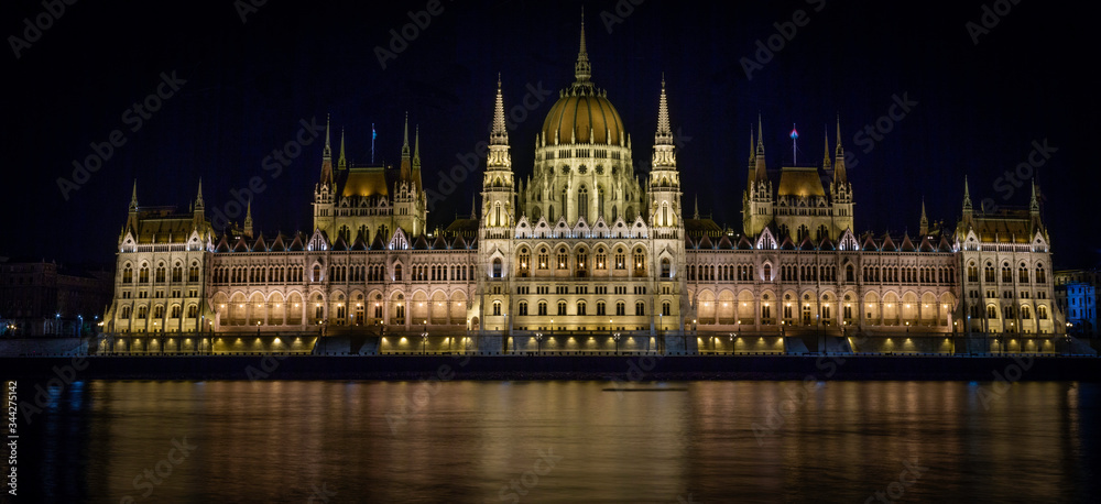 A panoramic to the Hungarian Parliament Building as the Danube River flows by in Budapest, Hungary.