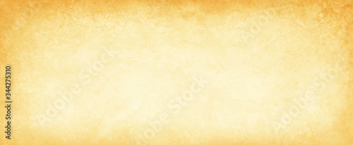 old yellow gold parchment paper background with dark yellowed vintage grunge texture borders and off white light center in distressed faded antique colors photo