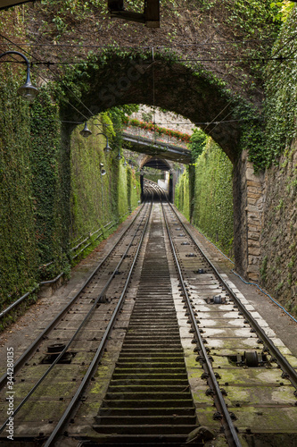 funicular up a steep hill from a mossy tunnel © Eloy