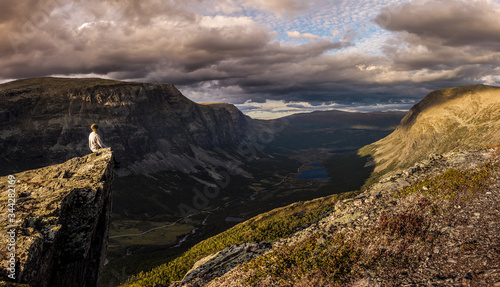 The mountain landscape in the evening  lonely adventurer on the edge. Norway  Hemsedal.