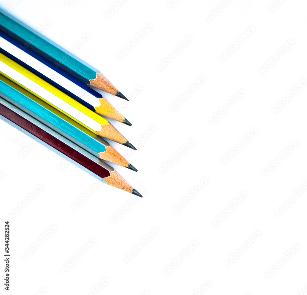 Few different colored wood pencil crayons arranged on a white background Few different colored wood pencil crayons arranged on a white background