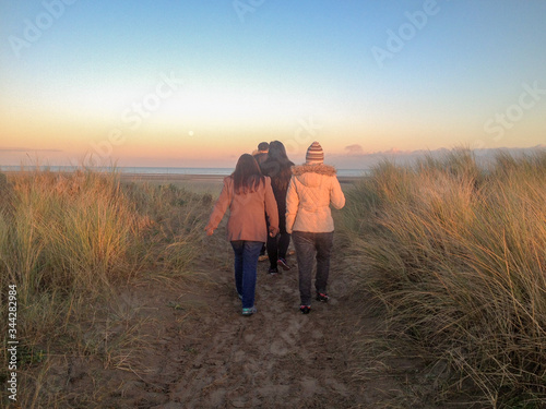 group walking on the beach