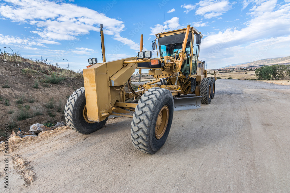Grader working on gravel leveling Grader working on gravel leveling