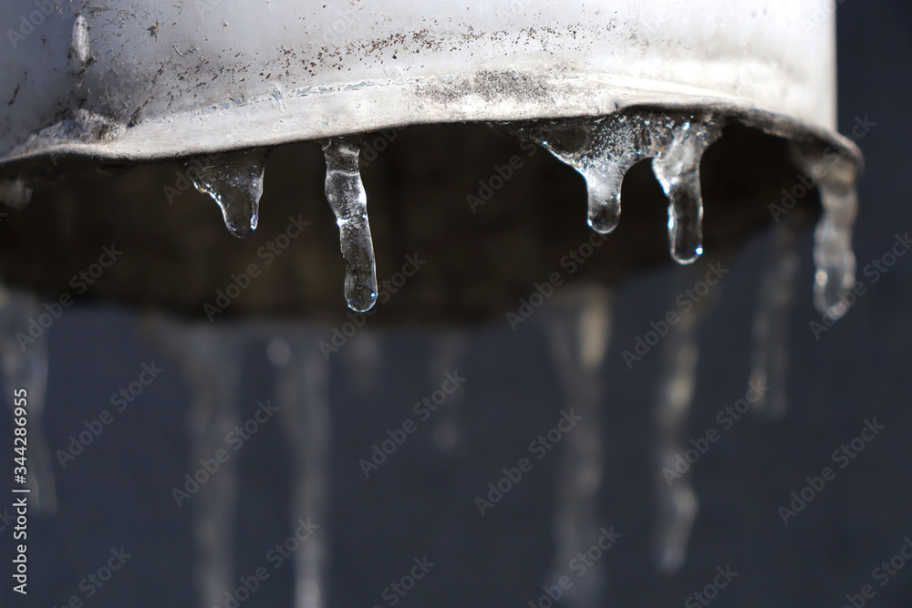 cicles. Small icicles on the drain. Melting icicles in the sun cicles. Small icicles on the drain. Melting icicles in the sun