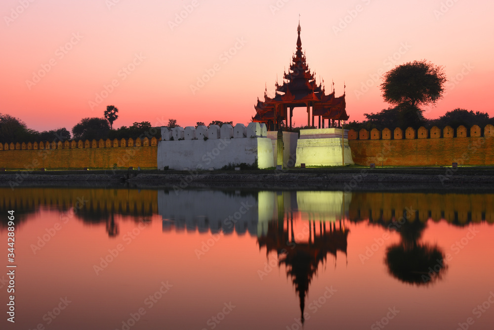Night view to the silhouettes of the Fort or Royal Palace in Mandalay, Myanmar (Burma) with red sunset sky Night view to the silhouettes of the Fort or Royal Palace in Mandalay, Myanmar (Burma) with red sunset sky