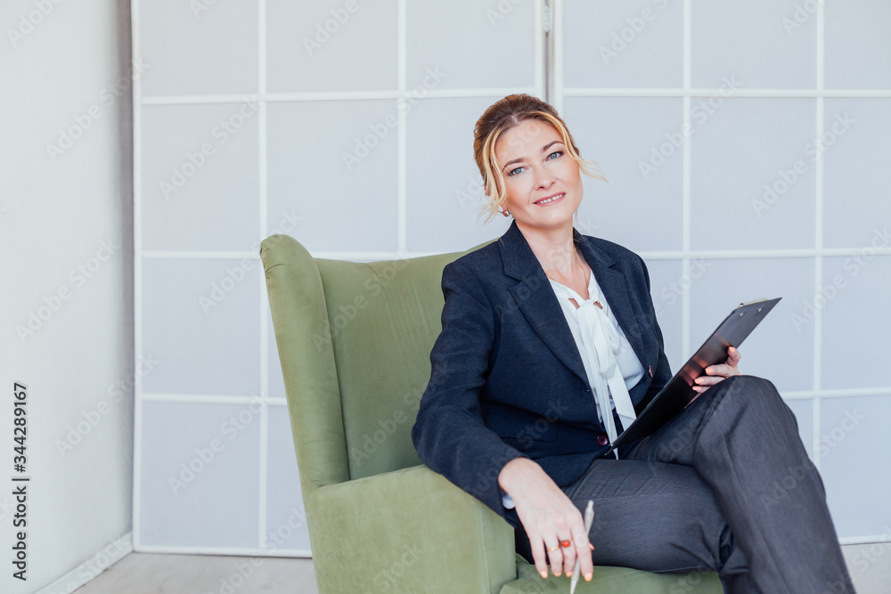 portrait of a business woman psychologist with documents at work in the office portrait of a business woman psychologist with documents at work in the office