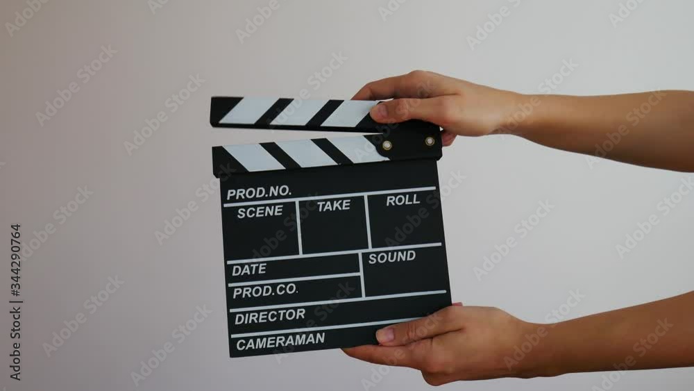 Female holding wooden clapperboard. Cinematography production concept. Copy space advertising mock up.