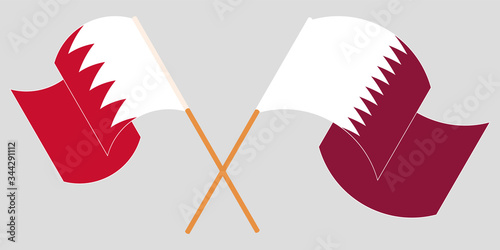 Crossed and waving flags of Bahrain and Qatar photo