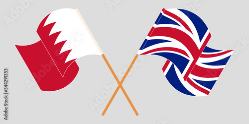 Crossed and waving flags of Bahrain and the UK