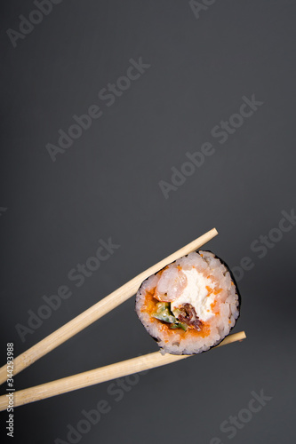 sushi and sushi sticks on a dark background