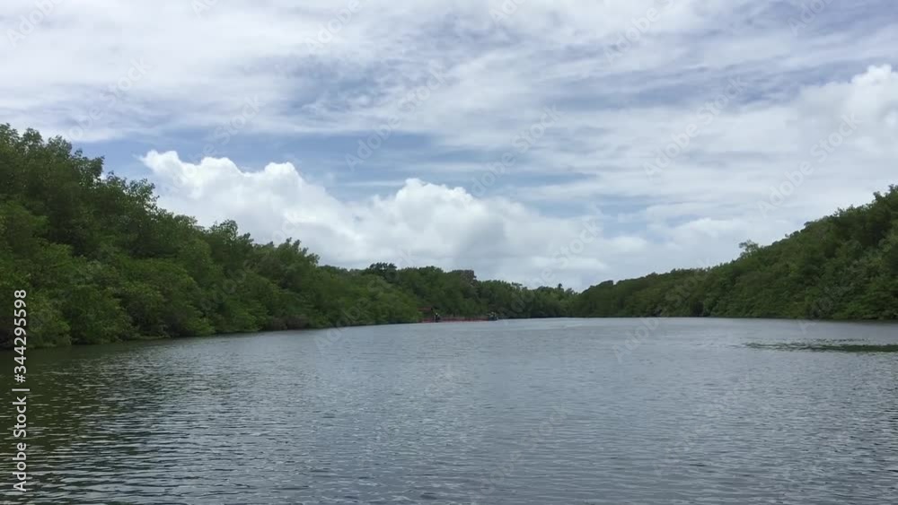 Sailing inland under the blue sky amid the forests. The boat's swing is noticed in the video. Sailing inland under the blue sky amid the forests. The boat's swing is noticed in the video.