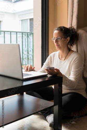 A woman sitting in front of a laptop.