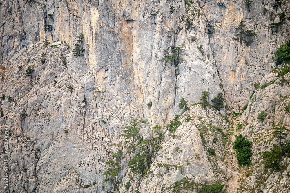 Spectacular view of the steep mountainside from the cab of the funicular. Cable car in the Crimean mountains, Ai-Petri. Nature stone texture. 