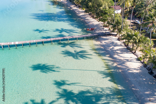Aerial drone view of palm tree shadows silhouette on tropical beach at Bang Bao Bay on island Thailand 