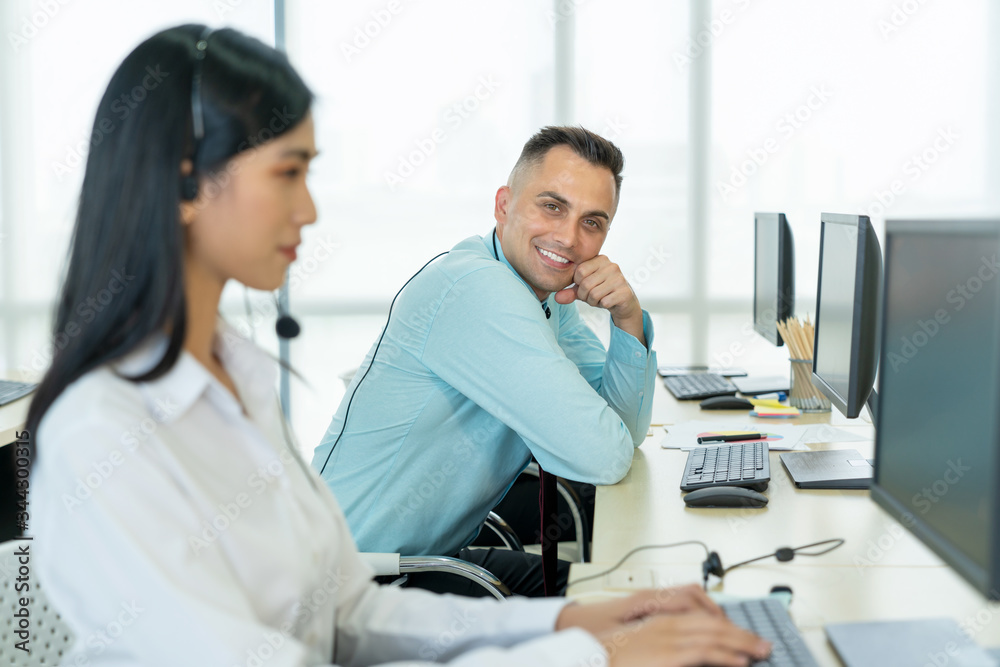 Happy operator working in the call center. Portrait of a technical support agent sitting at the office. Concept of Business telemarketing, Communication support. Happy operator working in the call center. Portrait of a technical support agent sitting at the office. Concept of Business telemarketing, Communication support.