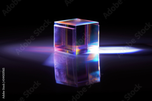 multicolored rays of light reflected by a crystal cube  photo