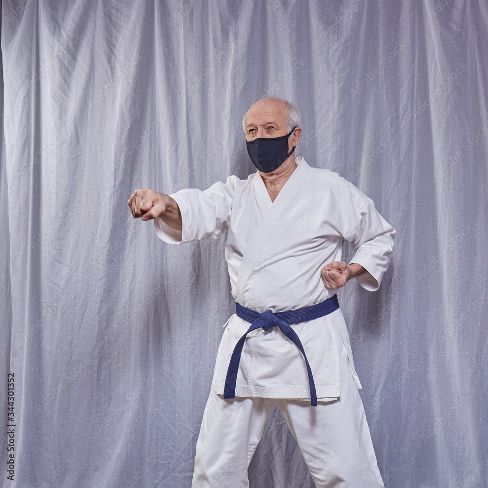 Old athlete trains formal karate exercises in self-isolation