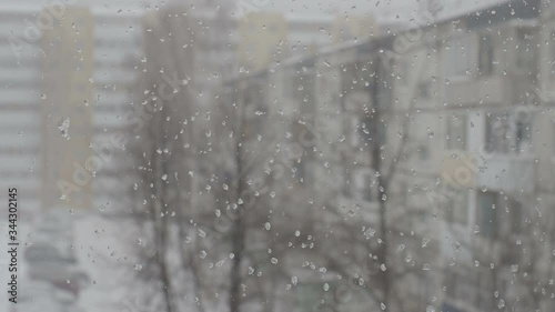 Blizzard in an urban environment. Abstract blurry winter weather background