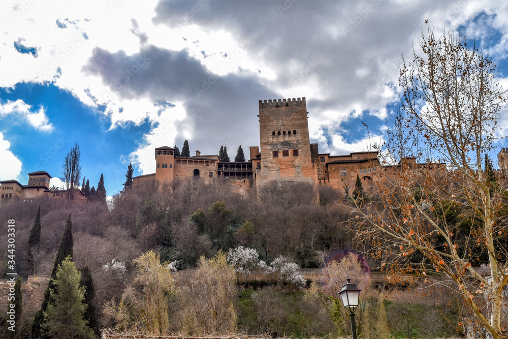 The Alhambra as viewed from below  with ominous clouds in the background.