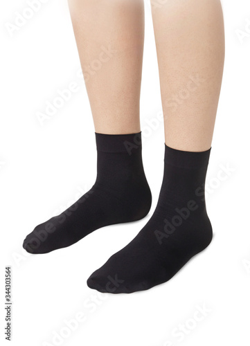 Black color socks isolated on white background. One pair of socks. Set of black socks for sports on foot as mock up for advertising, branding, design.