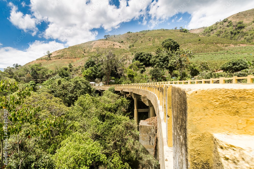 dramatic image of a bridge in the high mountain farmland and feilds of the Caribbean in the Dominican republic.